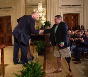 President Trump shakes hands with retired U.S. Army Sgt. Michael Verardo, during the President's remarks in the East Room of the White House, prior to signing the Department of Veterans Affairs Accountability and Whistleblower Protection Act of 2017. (Courtesy: The White House)
