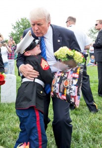 President Trump hugs Christian Jacobs, 6, at the grave of his father in Section 60 of Arlington National Cemetery in Arlington, VA on May 29. Christian joins his mother, Brittany, every year for Memorial Day. (U.S. Army photo by Elizabeth Fraser/Arlington National Cemetery/released)